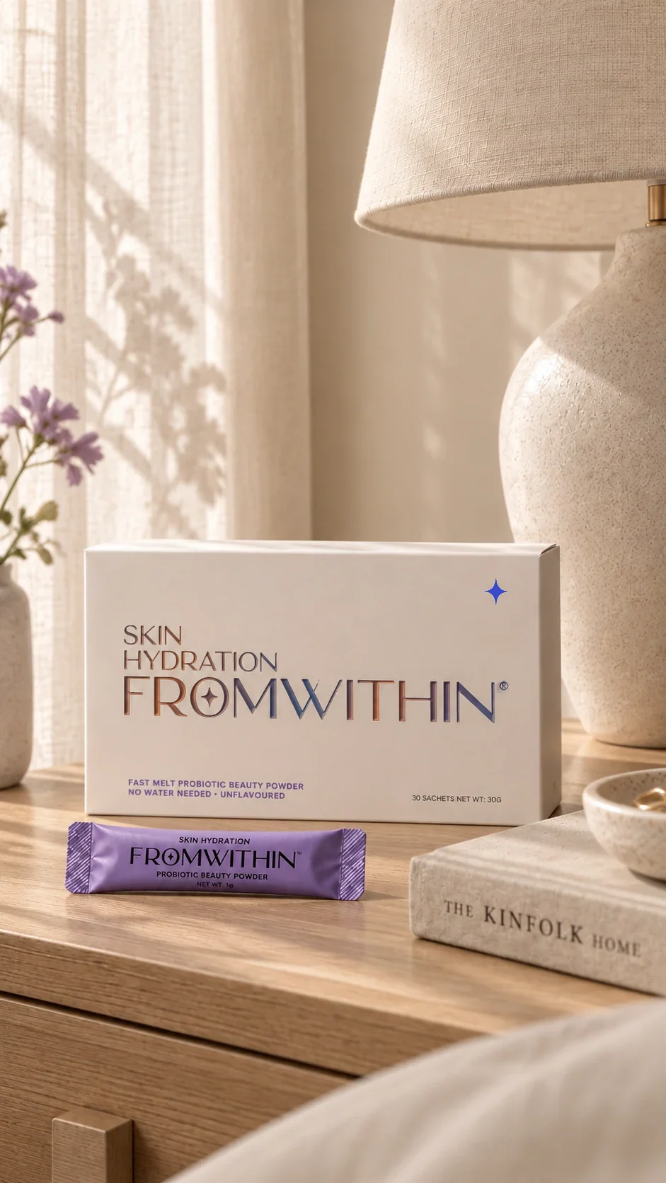 The FROMWITHIN box and sachet on a bedside table in morning light